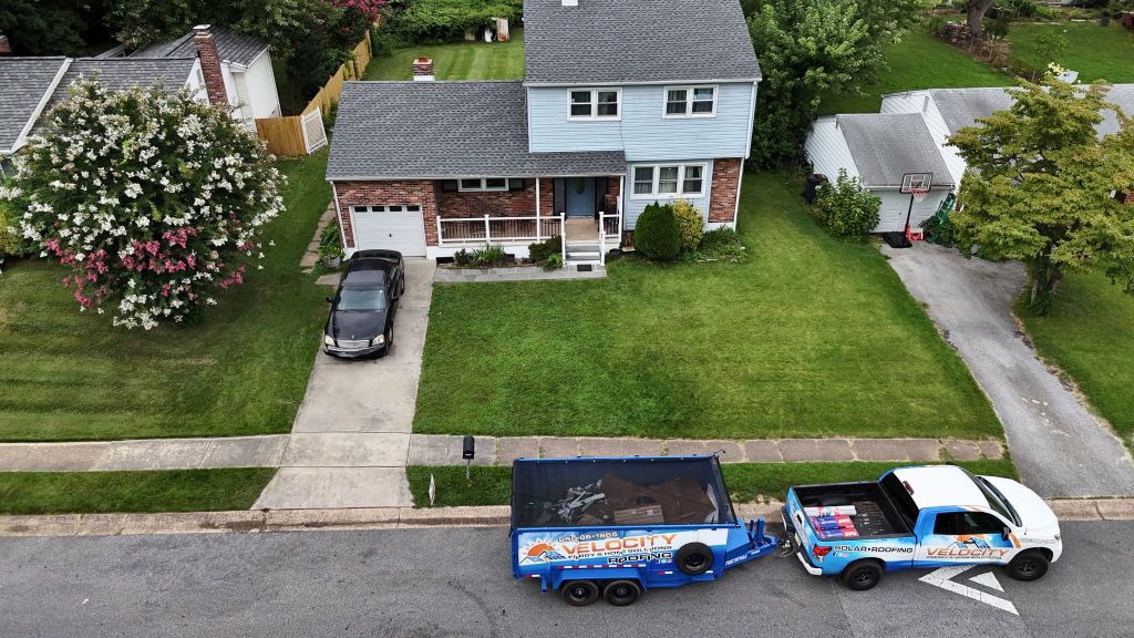 Velocity Roofing truck and trailer outside a completed South Jersey roof replacement