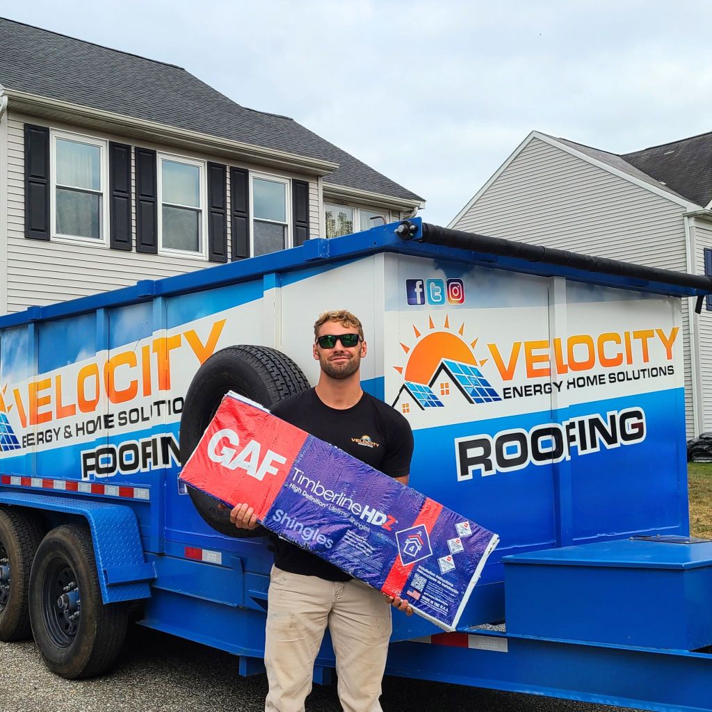 Velocity Roofing team member holding GAF Timberline HDZ shingles